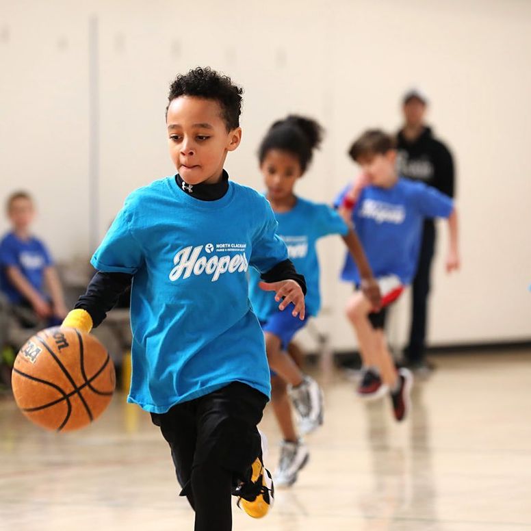 a child dribbling a basketball